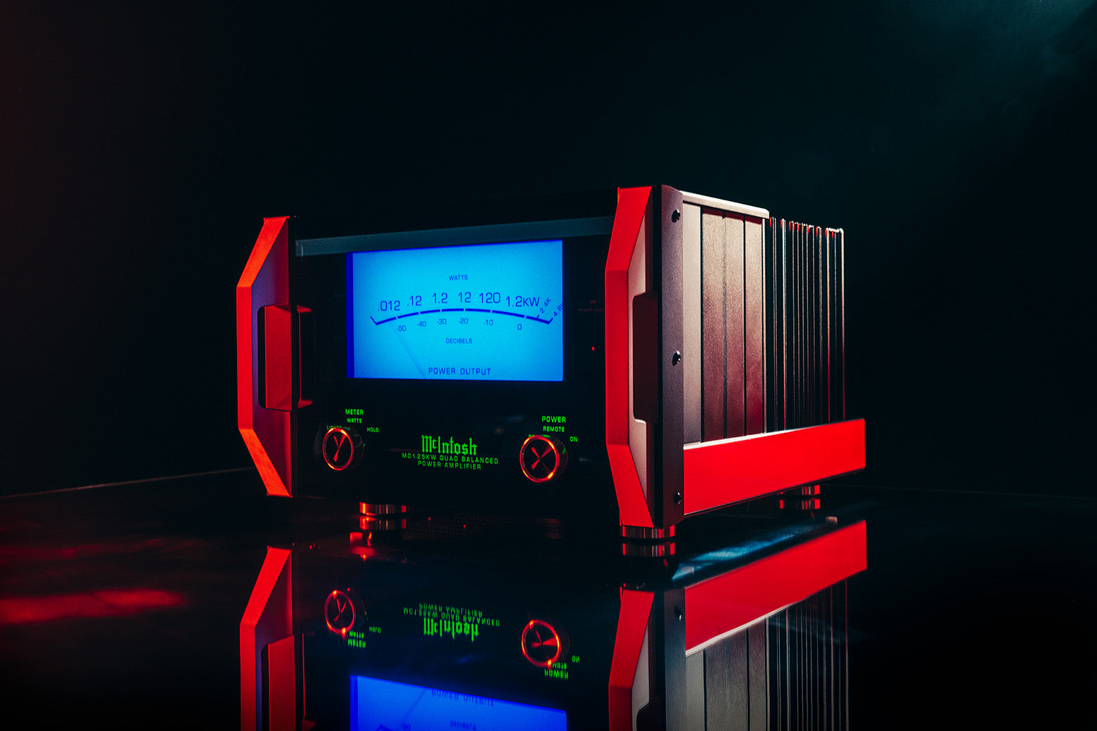 McIntosh MC1.25KW amplifier with its large blue Watt meter illuminated and red light across its handles.