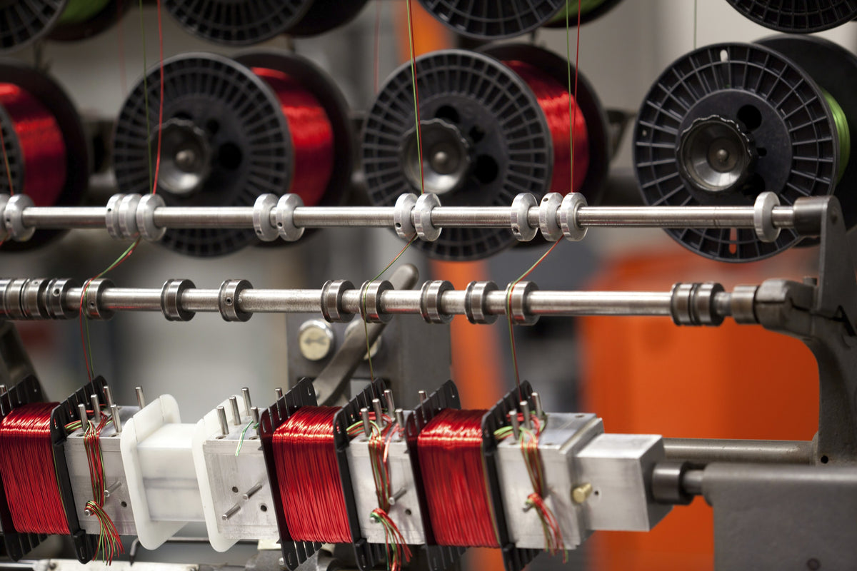 Spools of magnet wire feeding the transformer winding machines at McIntosh in Binghamton
