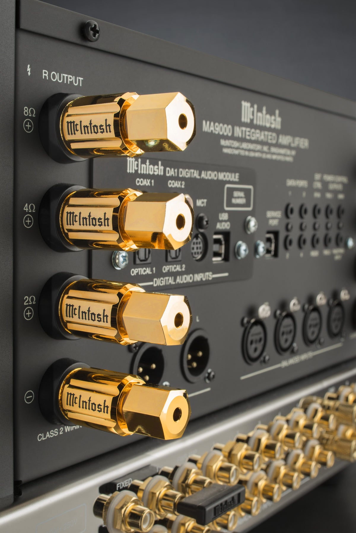 Gold-plated Solid Cinch speaker binding posts on the rear panel of a McIntosh integrated amplifier