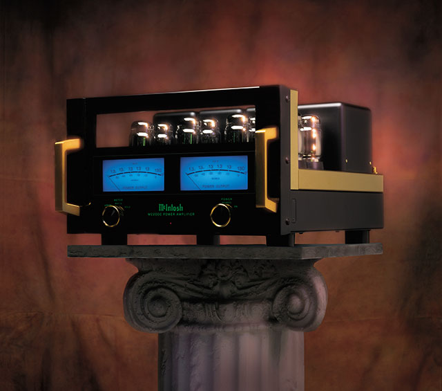 McIntosh MC2000 anniversary vacuum-tube amplifier with two illuminated blue meters and gold-colored handles.